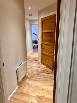 Enter a cozy room with a large bed and small table.