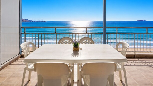 A covered outdoor dining area with a view of the sea and a ship in the distance. - BELL RACÓ Superior (La Pineda)