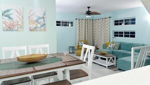 A dining area with a table, chairs, and a decorative basket. - Peaceful Hillside Retreat with Pool. (Ocho Rios)