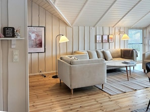 A modern living room with a sofa, a coffee table, and a lamp. - 4 Star Holiday Home in Sydals (Sydals)