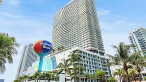 A tall hotel with a curved facade, palm trees, and a large sign reading "Hallsworth Beach". - The Sky is the Limit: Picturesque Condo on a High Floor!!! (Hollywood)