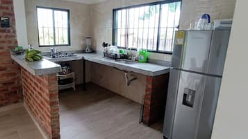 Fridge, cookware/dishes/utensils, lobster pot, dining tables