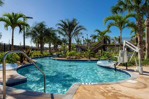 A swimming pool with a 3 FT depth marker, surrounded by palm trees and a covered area with stairs.