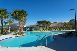 A swimming pool with a 4-foot depth marker, surrounded by palm trees and lounge chairs.