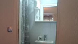 A bathroom with a white sink, a toilet, and a shower area. - Pansion Stones Murter - Double Room (Murter)
