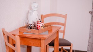 A wooden table with a tray containing a coffee maker, glasses, and a can of Nescafé. - Mountain Serenity Rooms - Double Room with Balcony 1 (Korenica)
