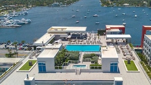 A rooftop pool area with a clear view of the marina and boats in the background. - Hollywood Beachfront Apartment at COSTA (Hollywood)