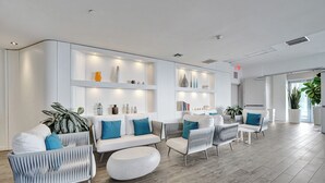 A modern interior with a sofa set, armchairs, and a coffee table.