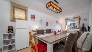 A compact living space with a dining area, a kitchenette, and a cozy seating area. - Studio in Allos with Stunning Mountain Views (Allos)