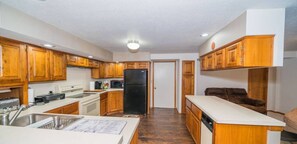 Private kitchen - 4-bedroom house in serene Sunrise Beach with AC, WiFi. Enjoy relaxation. (Sunrise Beach)