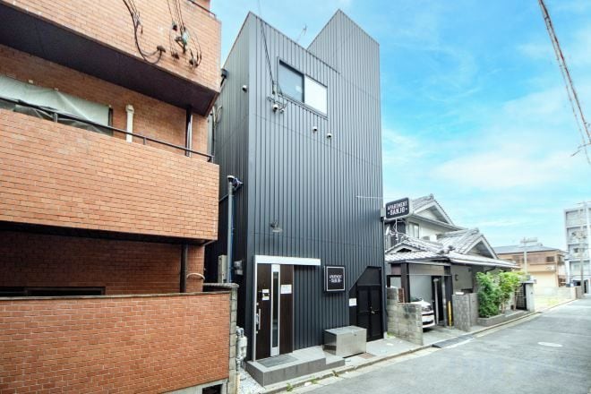 A modern building with a flat roof and a small entrance.