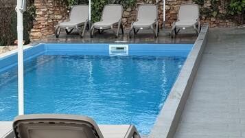 Seasonal outdoor pool, open 10:00 AM to 10:00 PM, pool umbrellas
