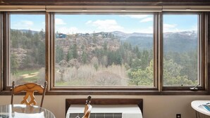 A room with a large window offering a view of a mountainous landscape. - Luxurious studio condo in lovely Durango, Colorado.  Stay and Play year round. (Durango)
