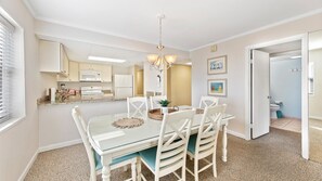 Enjoy meals in this stylish dining area with a glass-top table and comfortable seating.