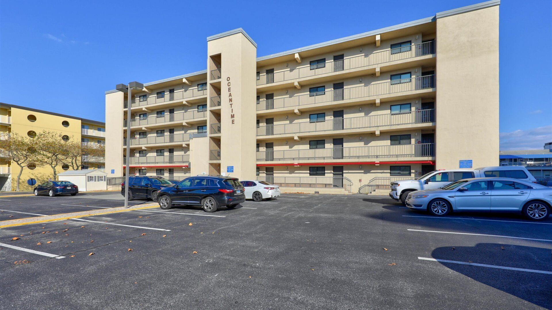 A multi-story parking garage with several cars parked.