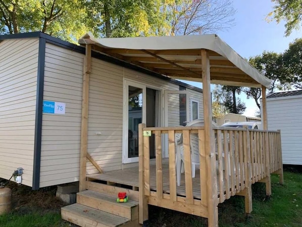 Step up to a cozy retreat with a covered porch and a single door.