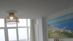 Moderni keittiö, jossa on ruokailutila, suuret ikkunat ja näkymä merelle.