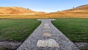 A pathway leading through a grassy field with a clear sky above. - Elk Run Ranch With Hot Tub (Tetonia)