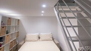 A bedroom with a bunk bed, a staircase, and a shelving unit with baskets. - Cozy suite ideally located for visiting major sights (Bari)