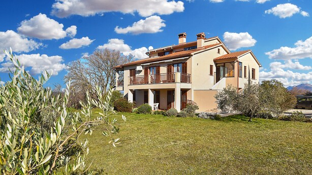 A two-story house with a balcony, surrounded by olive trees and a clear blue sky. - Apartment 2372/141541 (Istria - Presika), 5000m from the beach (Presika)