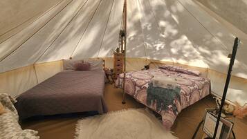 Two cozy sleeping areas with beds, bedside tables, and lamps, set amidst a warm and inviting atmosphere.