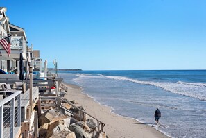 A beachside hotel with a wooden deck and a view of the ocean. - Oceanfront Retreat: 2BR Home with Private Beach Access, Firepit  
STR24-0040 (Dana Point)