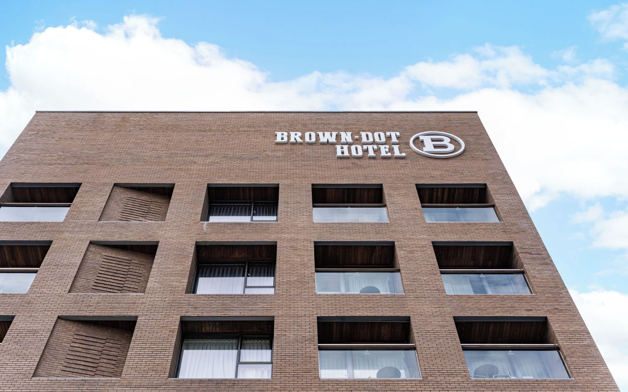A multi-story building with the sign 'BROWN-DOOT HOTEL' indicating a hotel property.