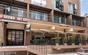 A hotel with a modern facade, outdoor seating area, and a visible entrance. - Brown-dot Hotel Haeundae (Busan)