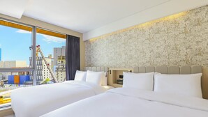 A hotel room with two beds, a large window, and a city view. - Brown-dot Hotel Haeundae (Busan)