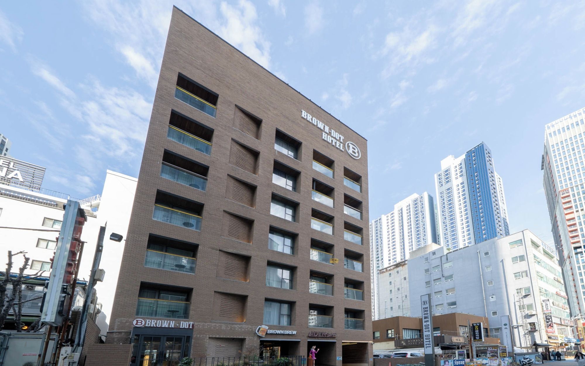A multi-story hotel with a prominent sign for the Brown-Dot Hotel.