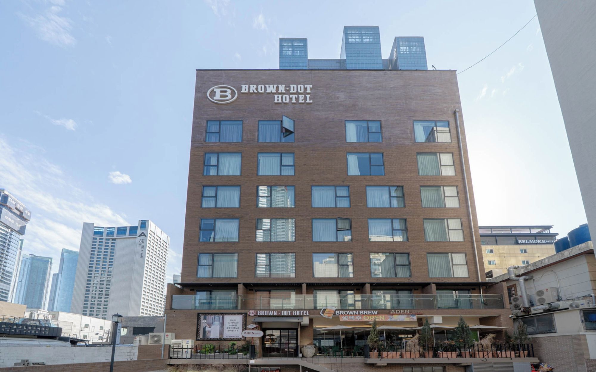 A multi-story hotel with a prominent sign for the Brown-Dot Hotel.