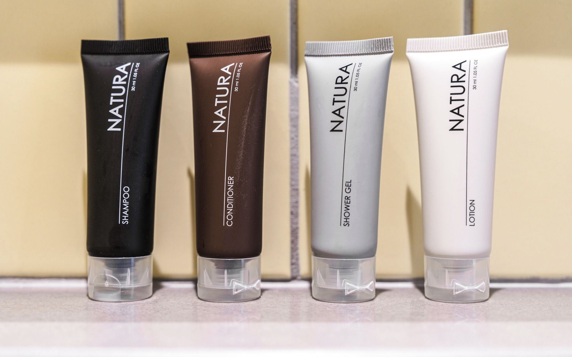Four tubes of Natura products on a shelf.
