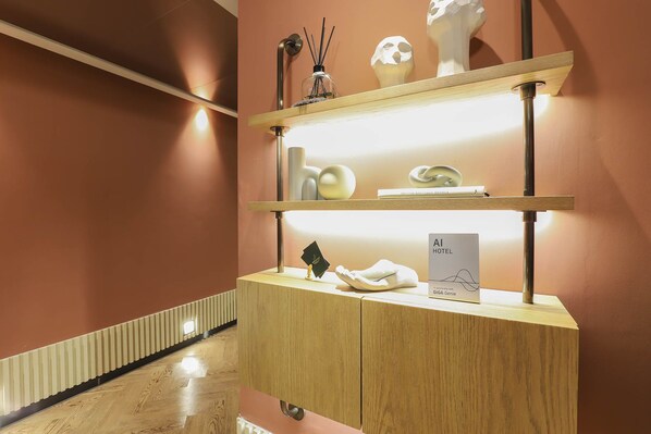 A hotel reception desk with a wooden finish, a glass display case, and a sign indicating the hotel name. - Brown-dot Hotel Haeundae (Busan)