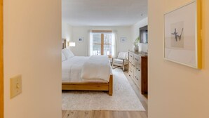 A bedroom with a wooden bed, a desk, and a chair. - Deer Park-Shuttle-Amenities- Fireplace (Woodstock)