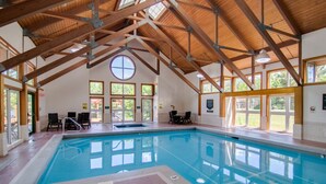 An indoor swimming pool with a high wooden ceiling and large windows. - Deer Park-Shuttle-Amenities- Fireplace (Woodstock)