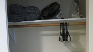 A closet with shelves, a hanging rack, and storage boxes. - Elite 2-bedroom apartment in Moose Creek with WiFi (North Pole)