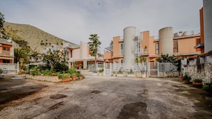 A residential area with multiple apartment buildings, a central open space, and surrounding greenery.