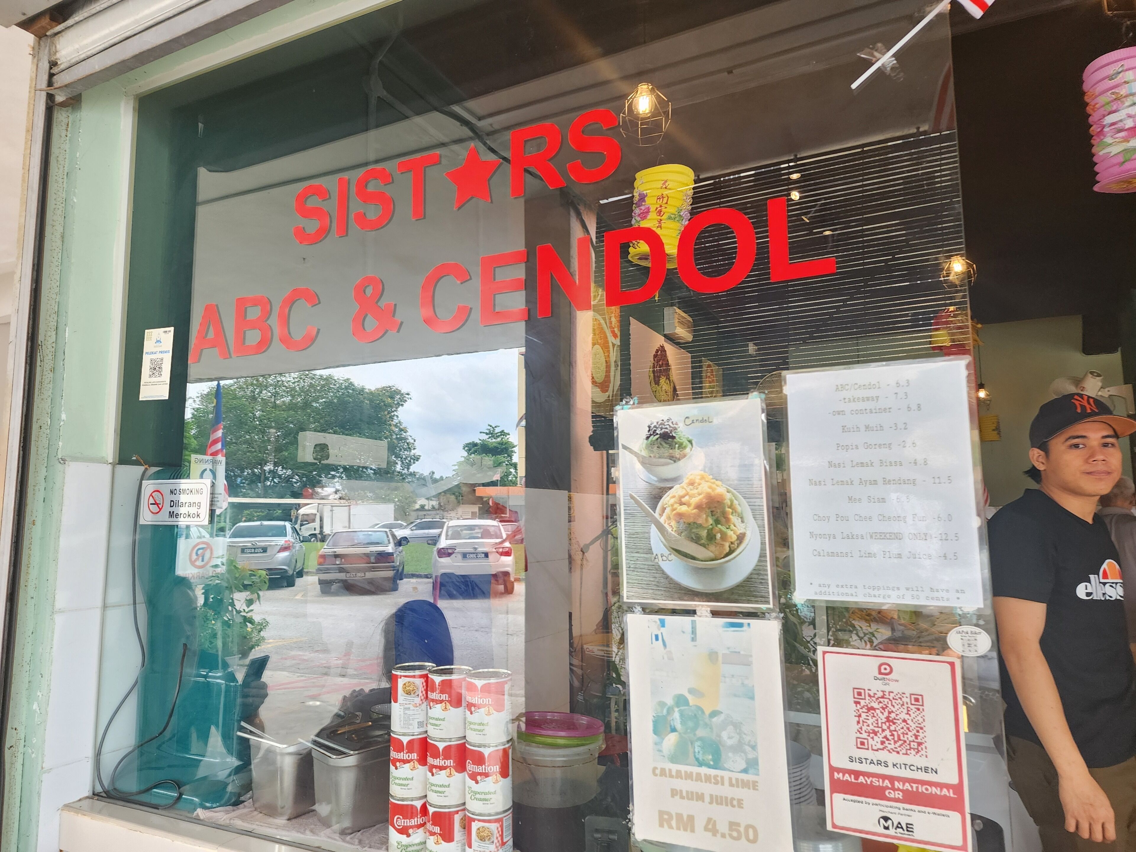 A storefront with a sign reading "SISTARS ABC & CENDOL".