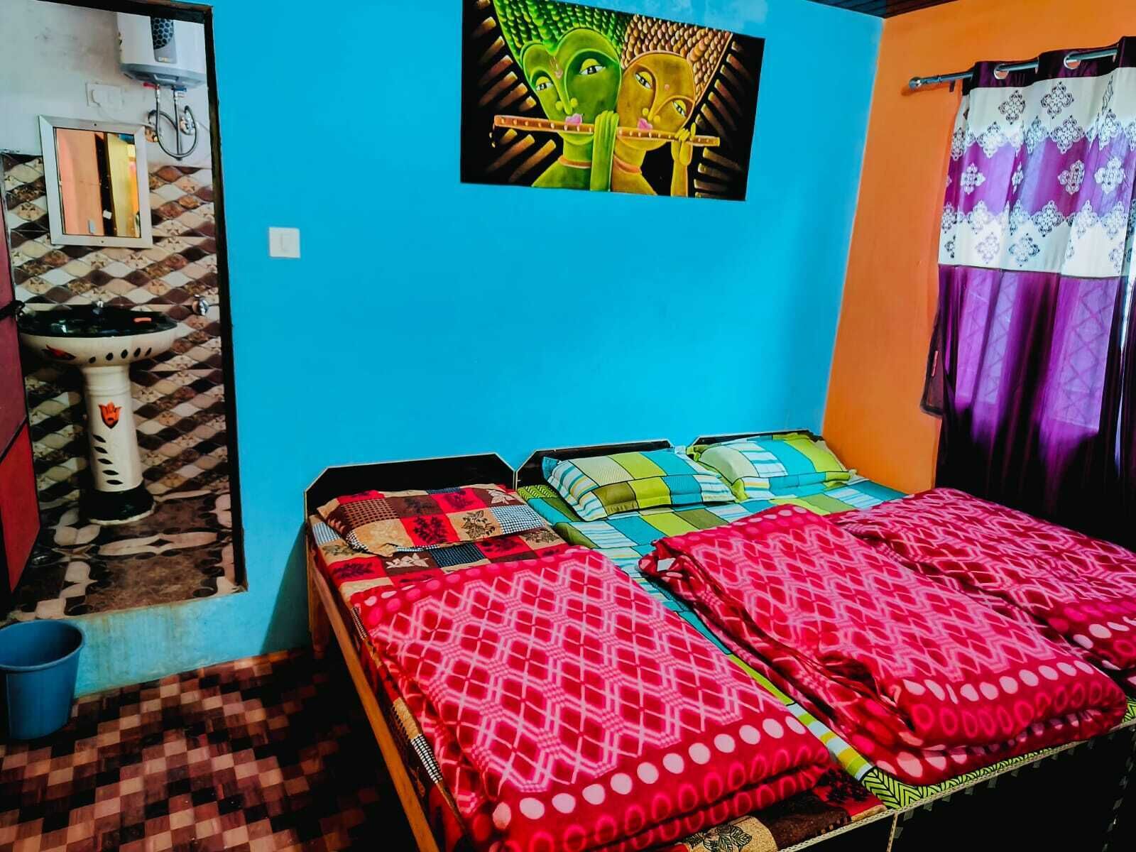 A room with a bed, a sink, and a wall-mounted air conditioner.