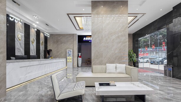 A modern lobby with a reception desk, seating area, and a large window overlooking the street. - Meihao Exquisite Hotel (Guangzhou)