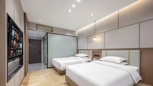 A hotel room with two beds, a television, and a minibar. - Meihao Exquisite Hotel (Guangzhou)