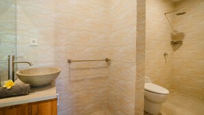 A bathroom with a large stone sink, a toilet, and a shower with a heart-shaped showerhead. - Comfortable Private Room in Canggu with High-speed WiFi (Bali)