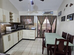 Fridge, microwave, coffee/tea maker, cookware/dishes/utensils