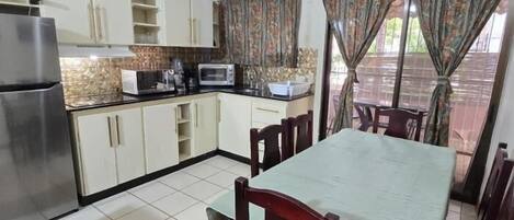 Fridge, microwave, coffee/tea maker, cookware/dishes/utensils