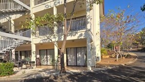 A multi-story building with balconies and a tree in the foreground. - Vista Hermosa D2 2 bed 2 bath Spacious & Fully Equipped Condo (Playa Hermosa)
