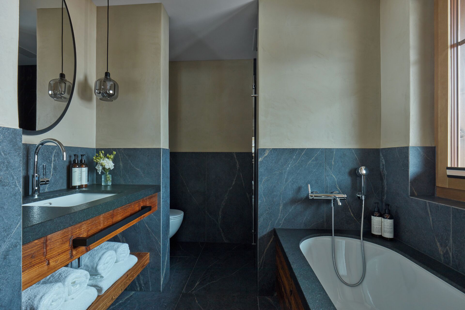 A modern bathroom with a vanity, sink, and bathtub.