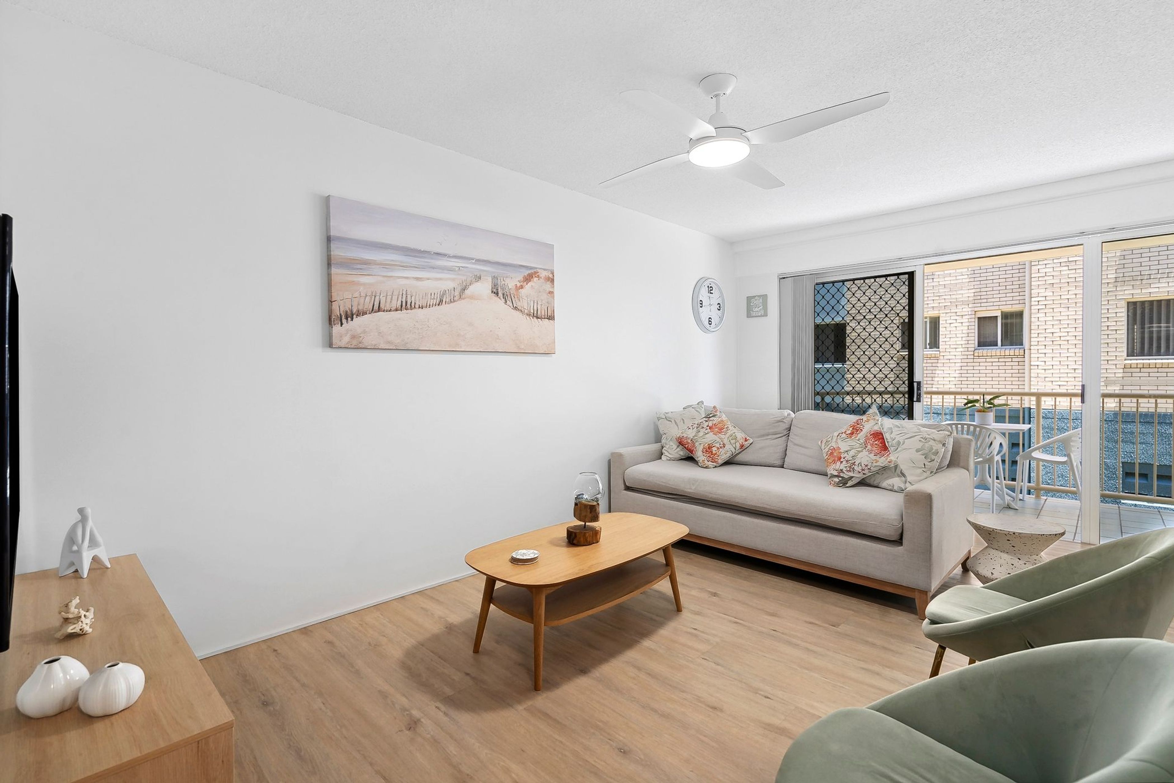 A modern living room with a sofa, coffee table, and chairs.