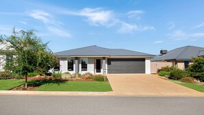 A single-story house with a garage, a front porch, and a well-maintained lawn.