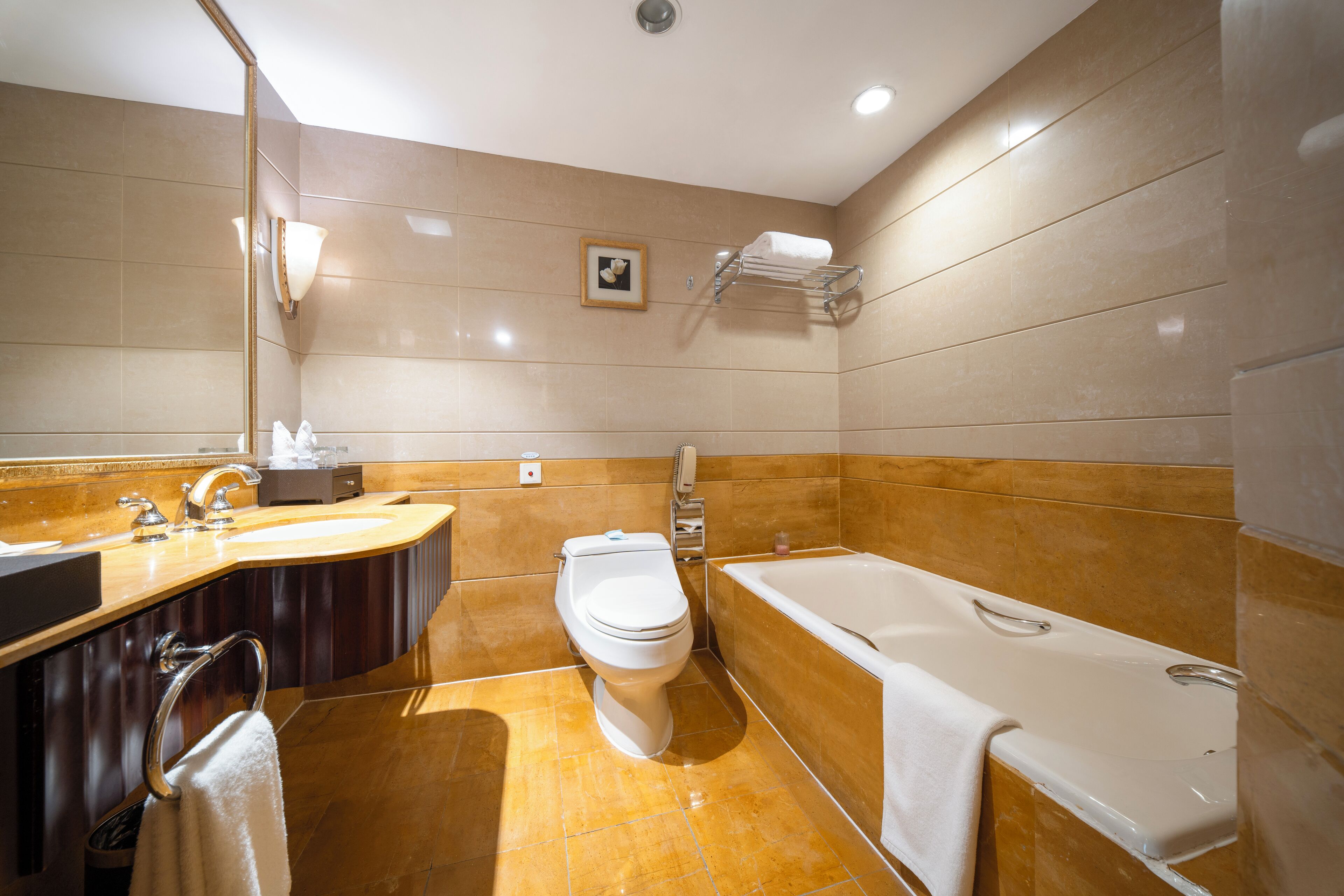 A modern bathroom with a toilet, sink, and bathtub.