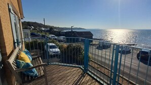 A balcony with a view of the sea and parked cars. - Princes Esplanade (Gurnard)
